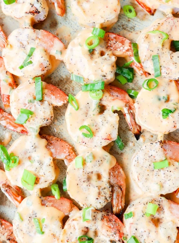 Bang bang shrimp grilled on skewers on platter