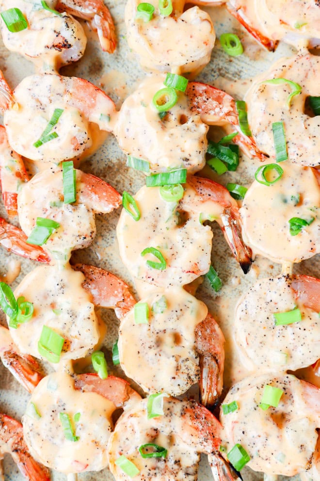 Bang bang shrimp grilled on skewers on platter
