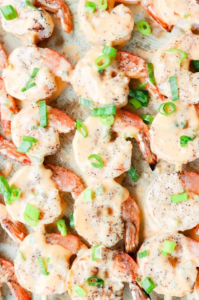 Bang bang shrimp grilled on skewers on platter