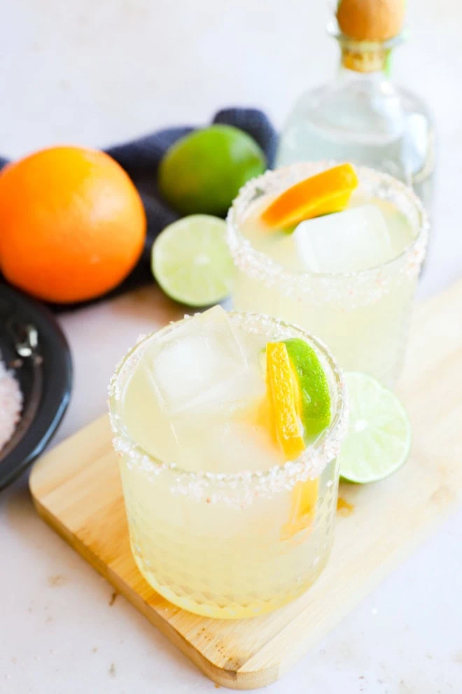 Patron margarita recipe in glasses with citrus garnish