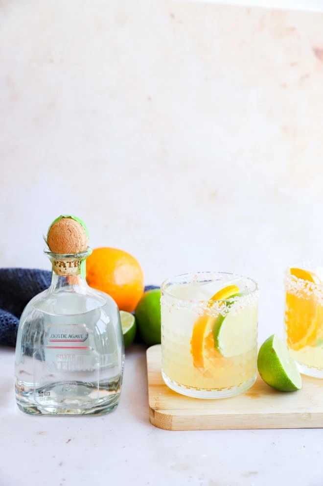 Silver tequila and cocktail in a glass with salt rim