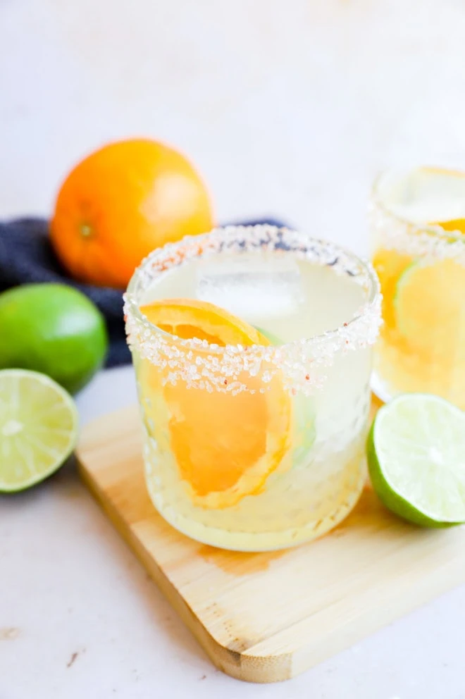 Fresh orange slice and lime halves with tequila cocktails