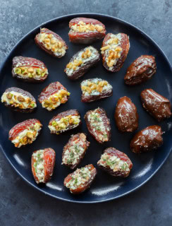 Stuffed dates four ways on a plate