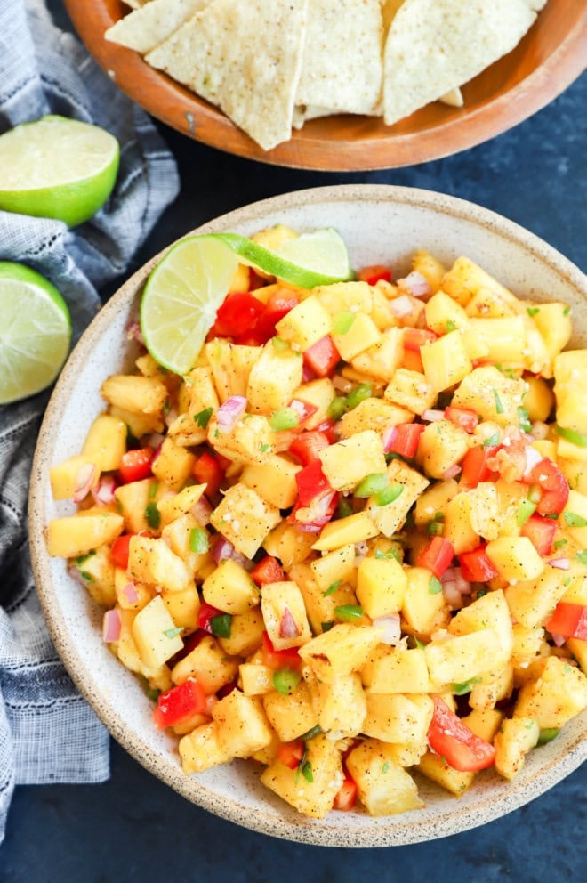 pineapple mango salsa in a bowl with tortilla chips on the side