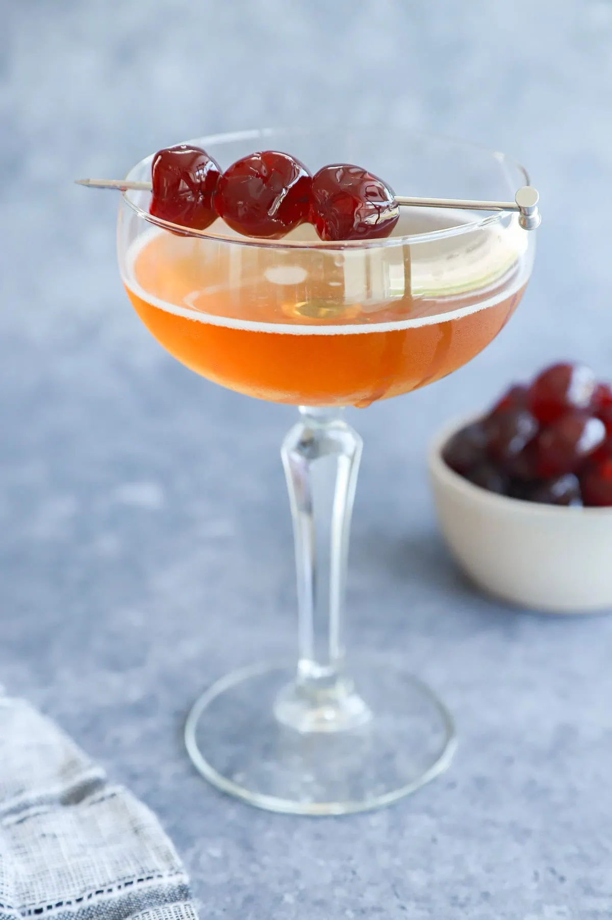 Low ABV cocktail in a coupe glass with cherry garnish