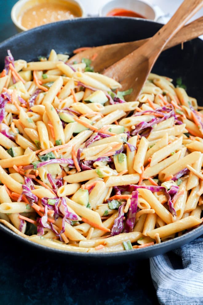 wooden utensils with noodles in a bowl