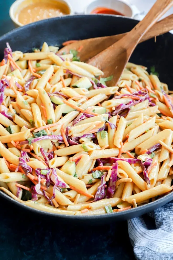 wooden utensils with noodles in a bowl
