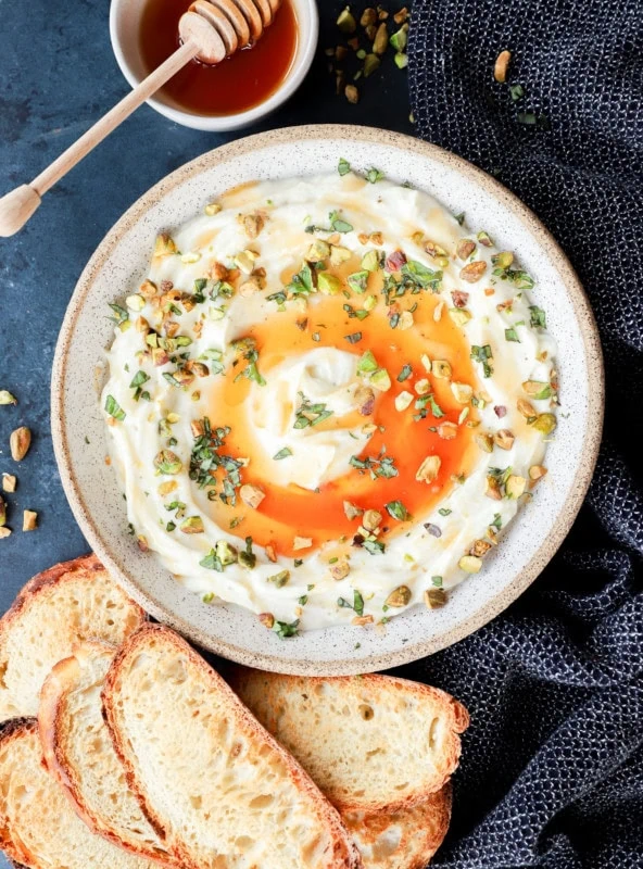 Cheesy dip with honey and toasted slices of bread