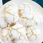 pretty cracked amaretti cookies on plate with linen and green countertop