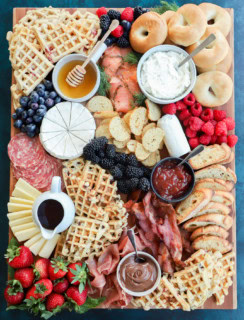 easy breakfast charcuterie board with fresh fruit, meats, cheeses, waffles, and more