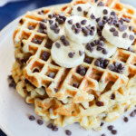 stack of banana chocolate chip waffles with fresh banana slices and chocolate chips