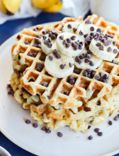 stack of banana chocolate chip waffles with fresh banana slices and chocolate chips
