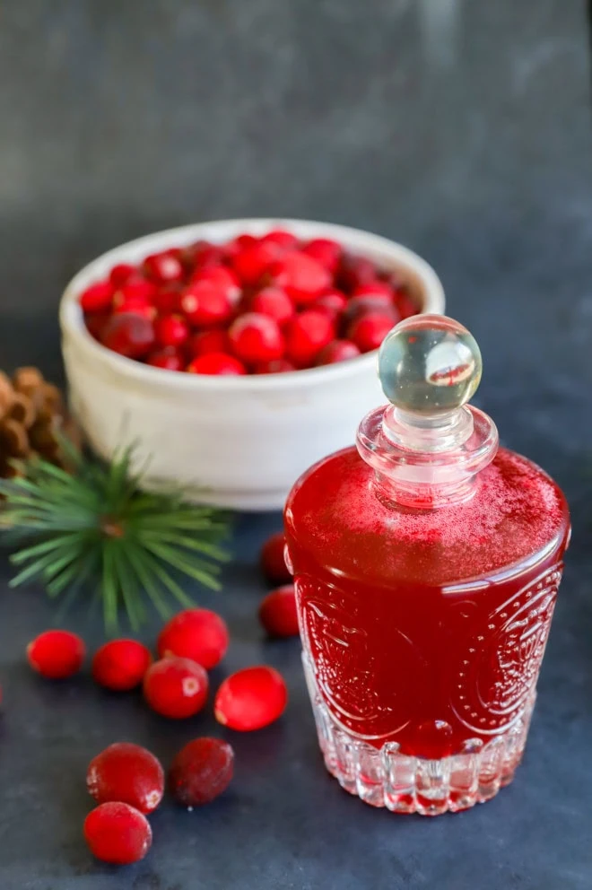 tart sweetener in bottle with bowl of cranberries behind