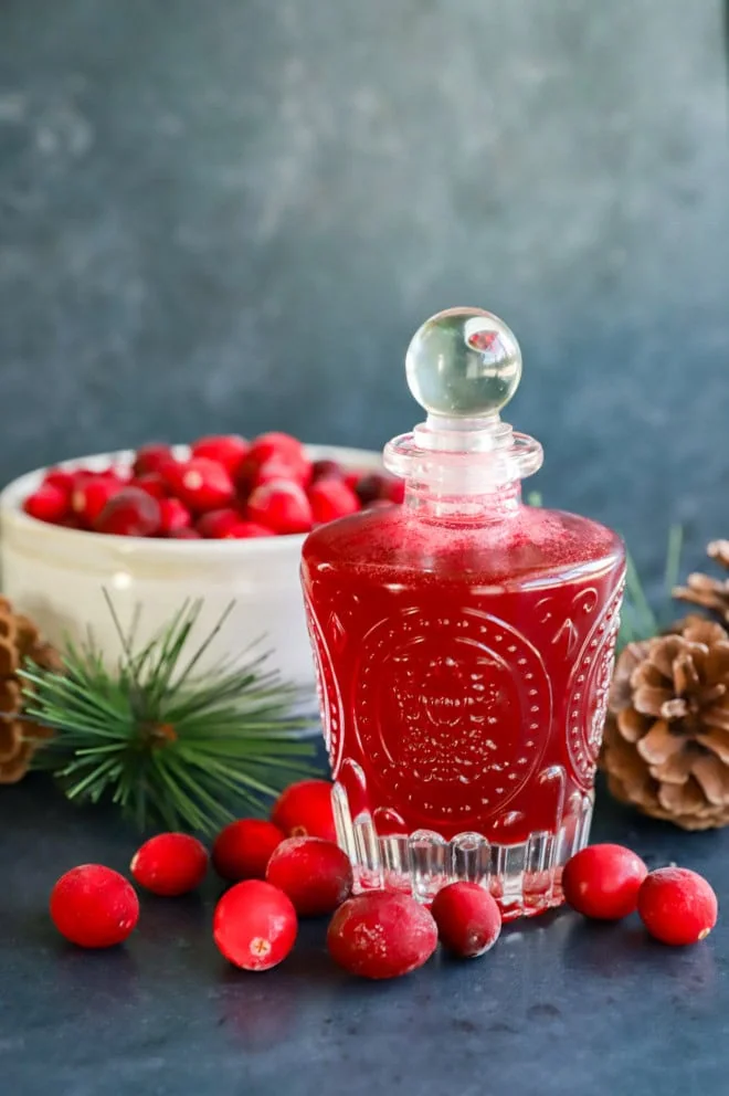 tart sweetener in bottle with bowl of berries behind