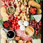 easy meat and cheese spread on cutting board with fresh produce