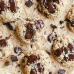 oatmeal chocolate chunk cookies on parchment paper with chocolate chunks