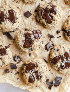 oatmeal chocolate chunk cookies on parchment paper with chocolate chunks