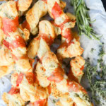 easy puff pastry italian appetizer on parchment paper with fresh herbs