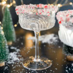 peppermint martini in coupe glass with little trees and lights