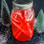 candy cane liquor in bottle with candies and fake snow