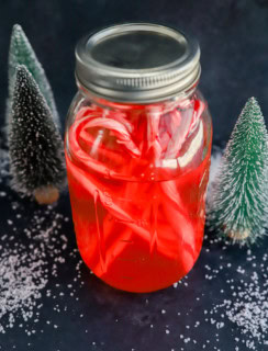 candy cane liquor in bottle with candies and fake snow