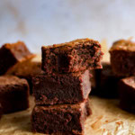 stack of coffee brownies with flaky sea salt on paper