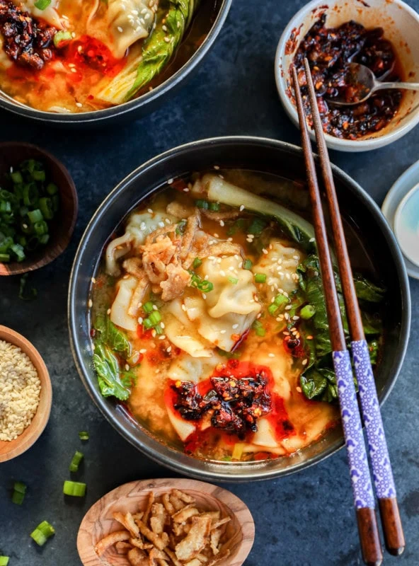 30 minute dumpling soup in bowls with chopsticks and chili crisp