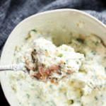 spoonful of compound butter with fresh parsley thyme and basil