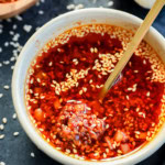 spoon in bowl of chili garlic oil recipe
