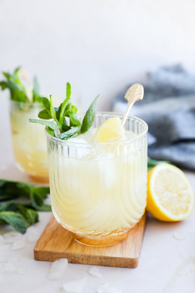 easy lemon cocktail with mint and lemons on cutting board