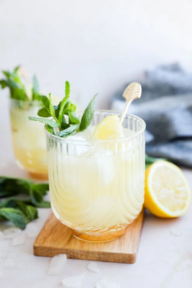 easy lemon cocktail with mint and lemons on cutting board