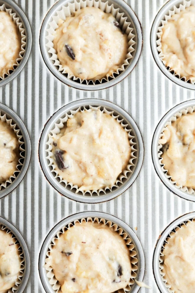 Banana chocolate chunk muffins in muffin tin before baking