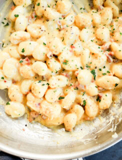 Gnocchi carbonara in a skillet cooking