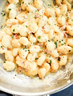 Gnocchi carbonara in a skillet cooking