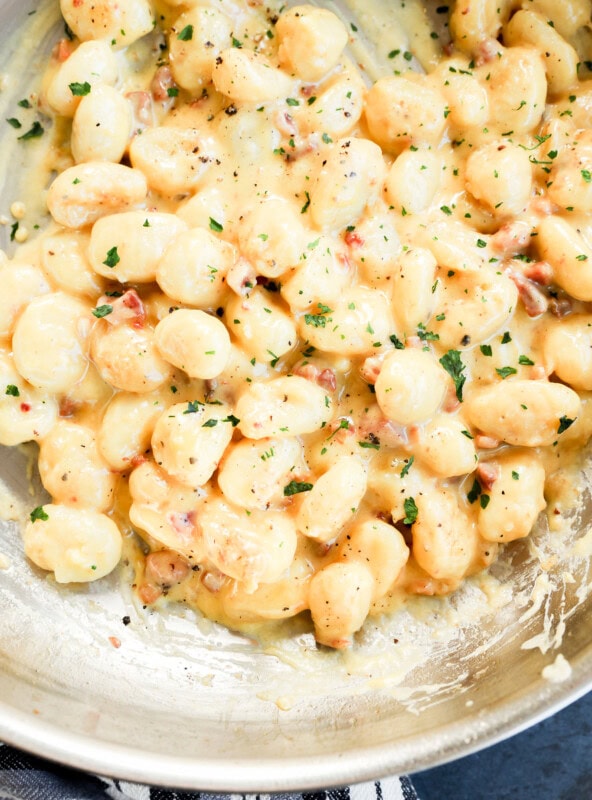 Gnocchi carbonara in a skillet cooking