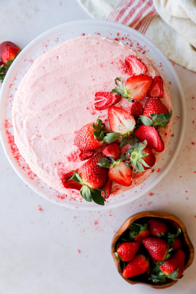 strawberry cake with strawberry filling on white cake plate