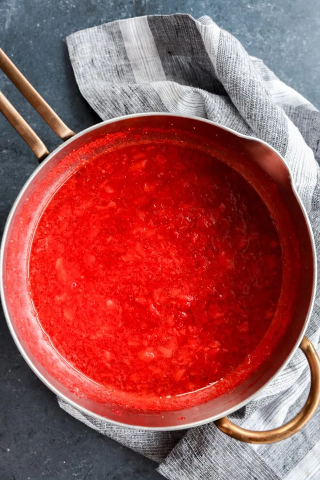 saucepan of cooling berry compote with linen