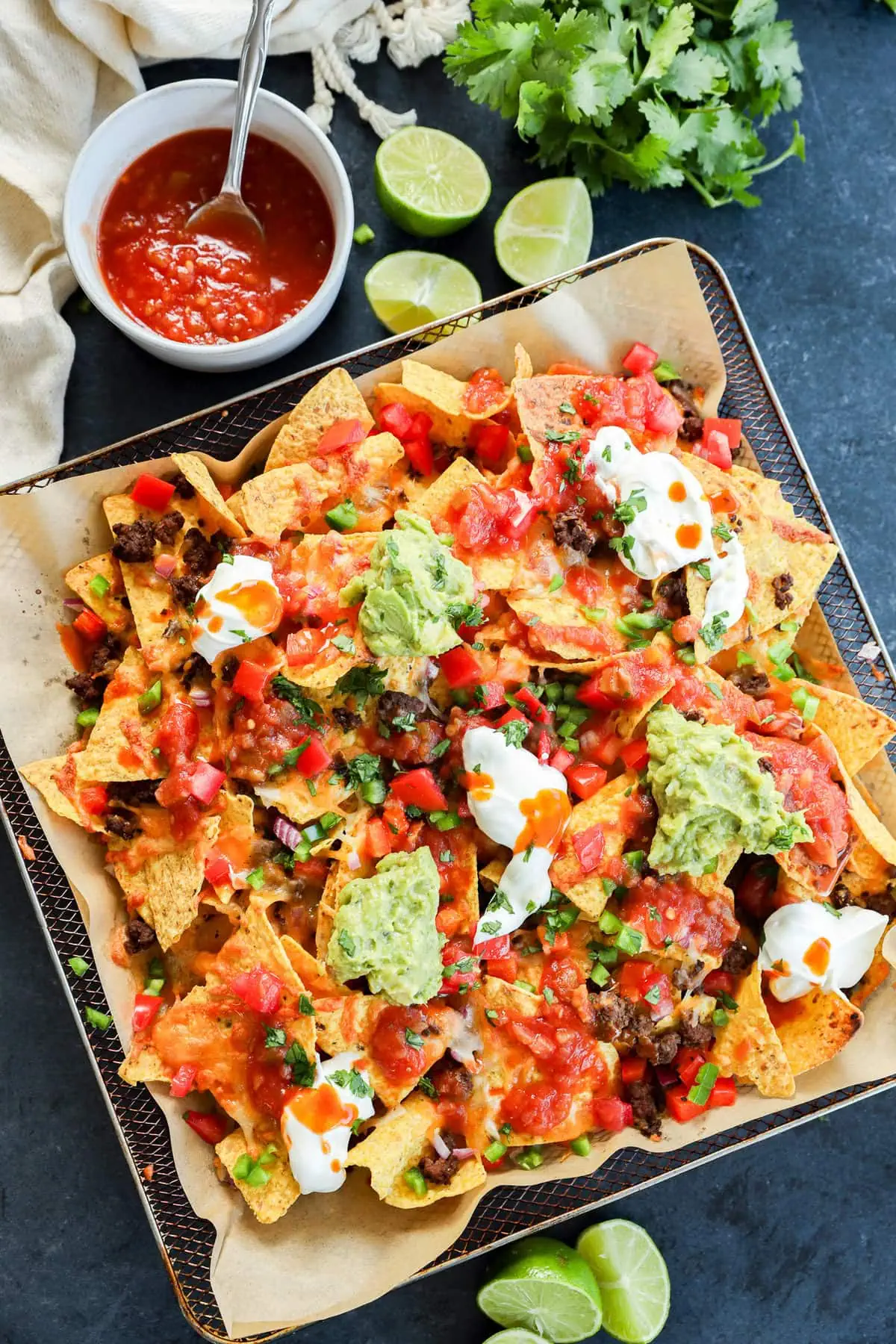 easy Air fryer nachos in pan with toppings
