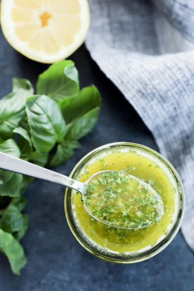 Spooning out condiment made with fresh herbs and lemon