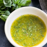 Fresh herb condiment in a bowl with fresh herbs and linen