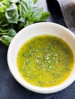 Fresh herb condiment in a bowl with fresh herbs and linen