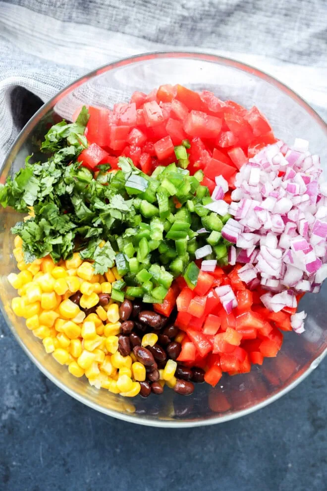 making Black bean corn salsa dip in a bowl