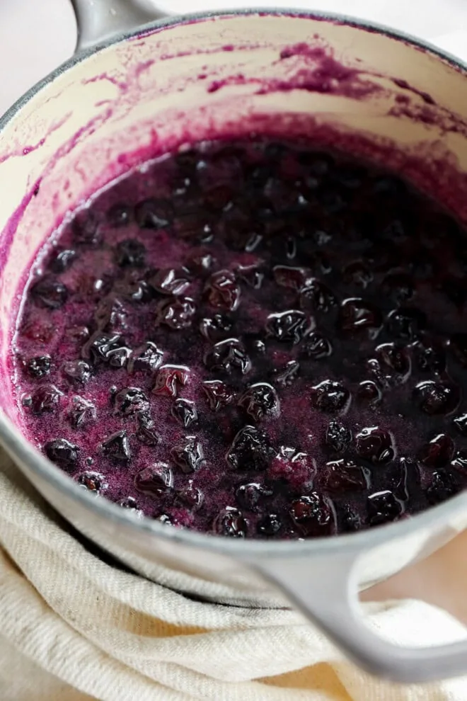 cooking blueberries in a saucepan with sugar and water