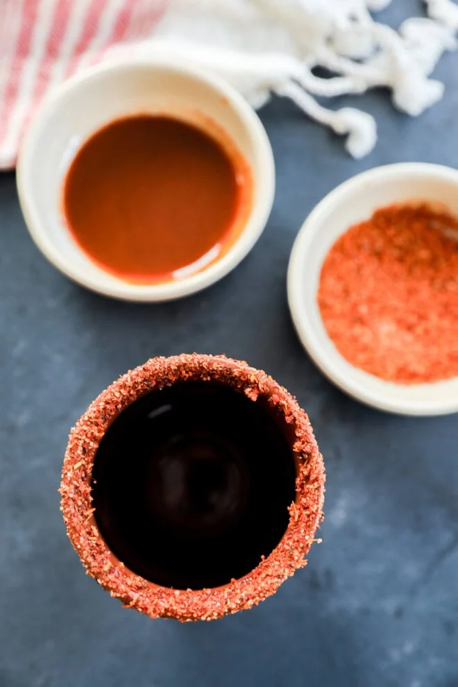 clay cup rimmed with chamoy and tajin seasoning