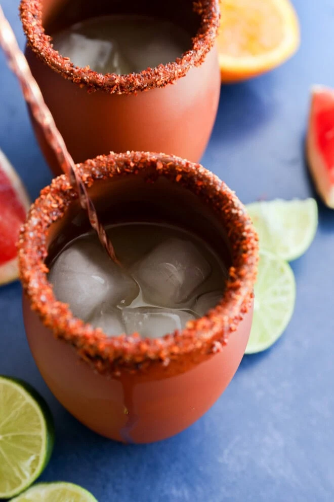 Stirring a Cantarito in a clay glass