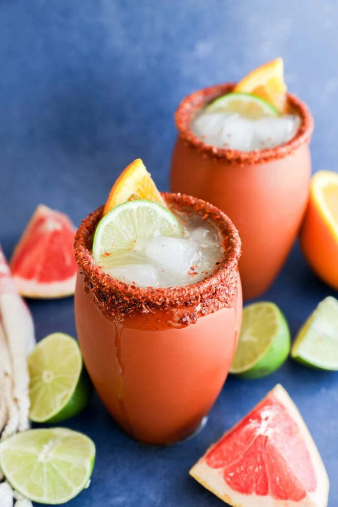 Easy Mexican citrusy cocktail in clay cups with fresh citrus