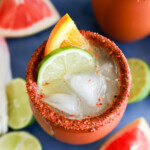 Fresh citrus garnish on clay cup with fresh cocktail in it