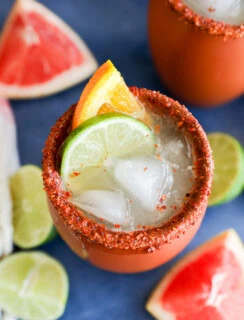 Fresh citrus garnish on clay cup with fresh cocktail in it