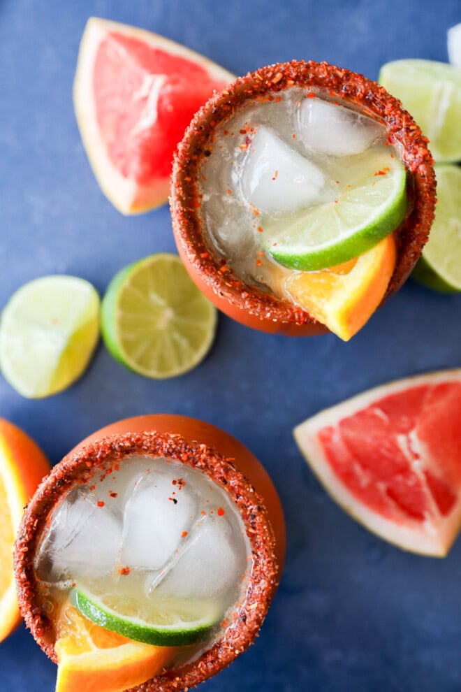 Cantarito cocktails in clay cups with fresh citrus all around