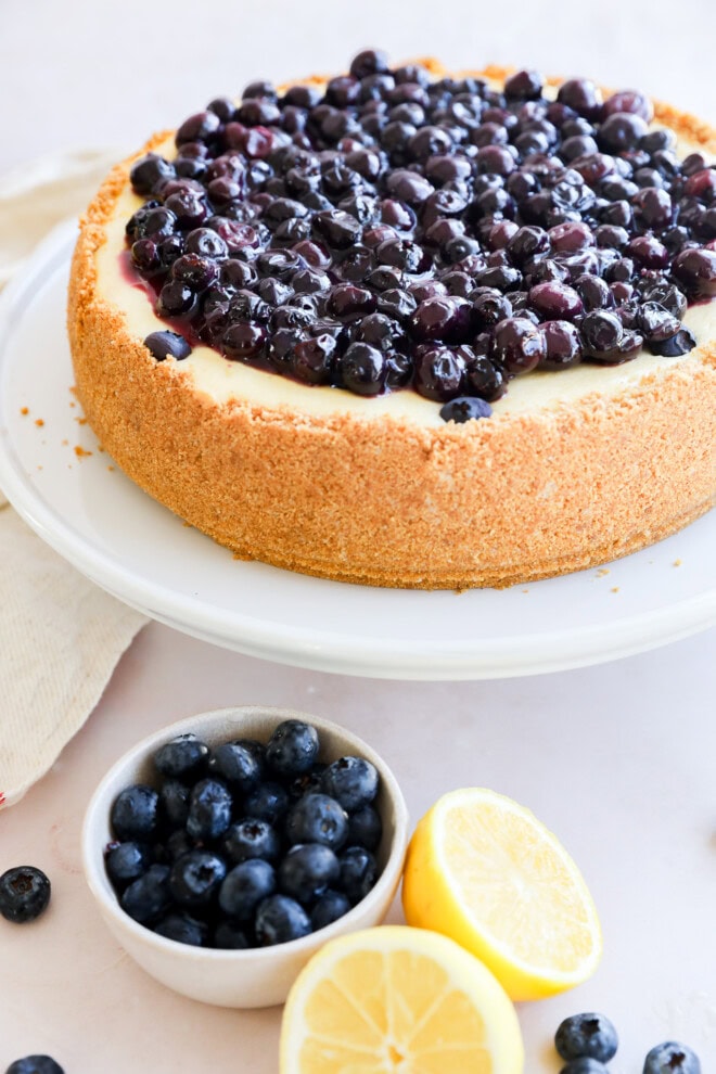 spring summer dessert on cake stand with fresh berries in bowl